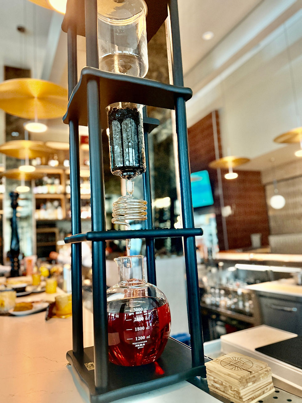 A sleek slow-drip cold brew coffee tower, showcasing its intricate brewing process and elegant design.