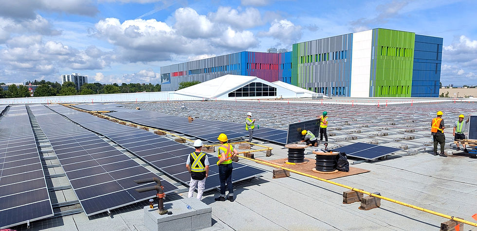 OREC PM Eric Gladu and OREC GM Marion Siekierski (foreground) viewing construction progress of the 660 kW DC expansion on the roof of the Canada Science & Technology Museum - Ingenium, 8 July, 2025.