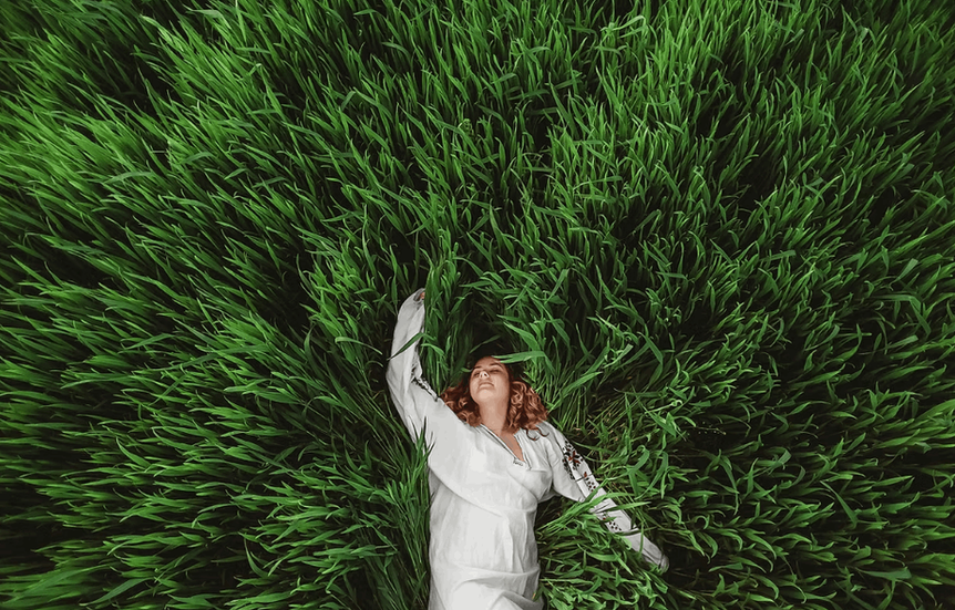 A woman immersed in a green field