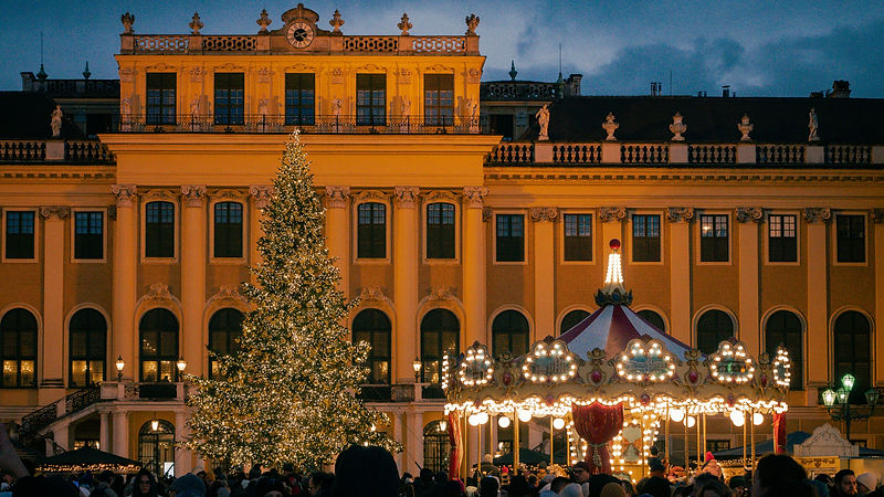 A large christmas tree in front of a bui