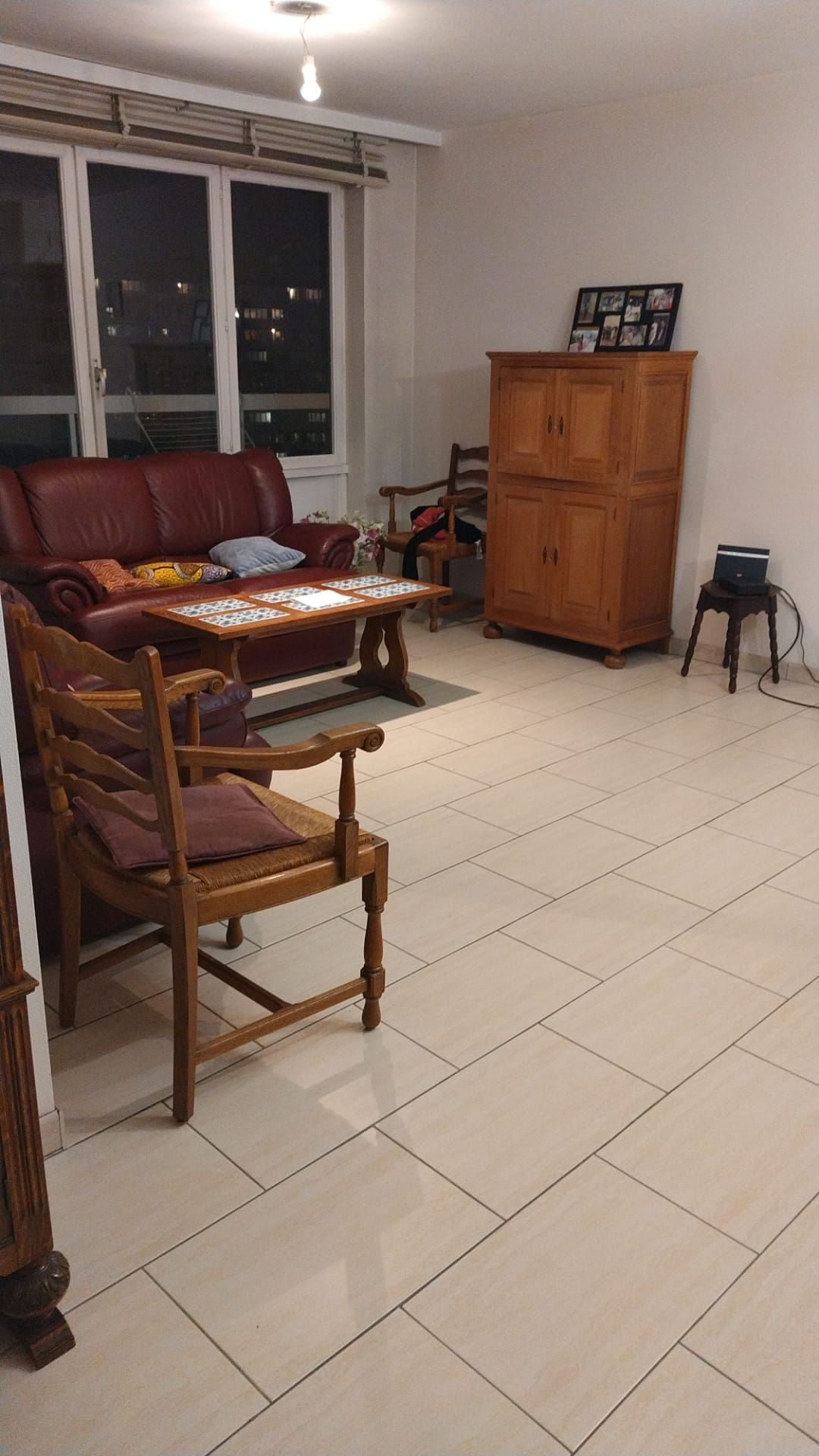 A living space comprising a sofa, a chair and a wooden table, creating a pleasant setting in which to relax, highlighting the interior design to be created.