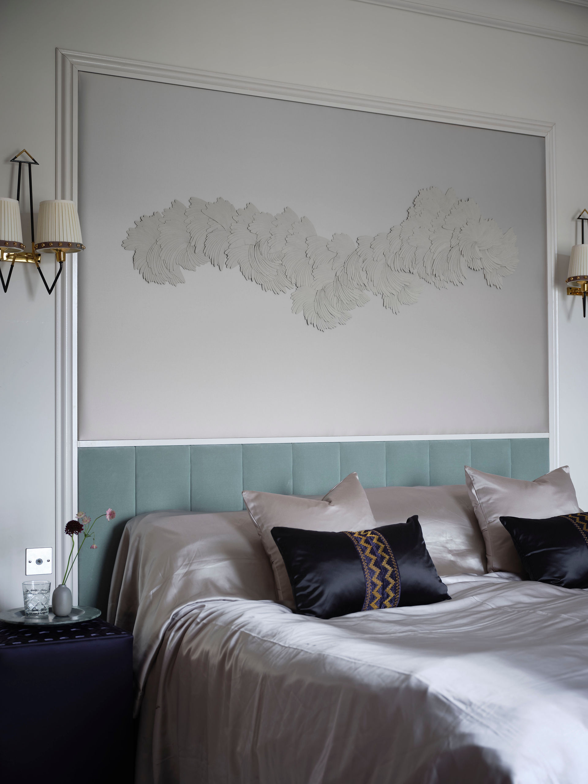 Bedroom interior with large textile art piece above the headboard by Aileen Daly