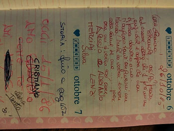 Handwritten Italian notes on a pink calendar page, with dates Oct 6–7, names, hearts, and red/blue ink doodles.