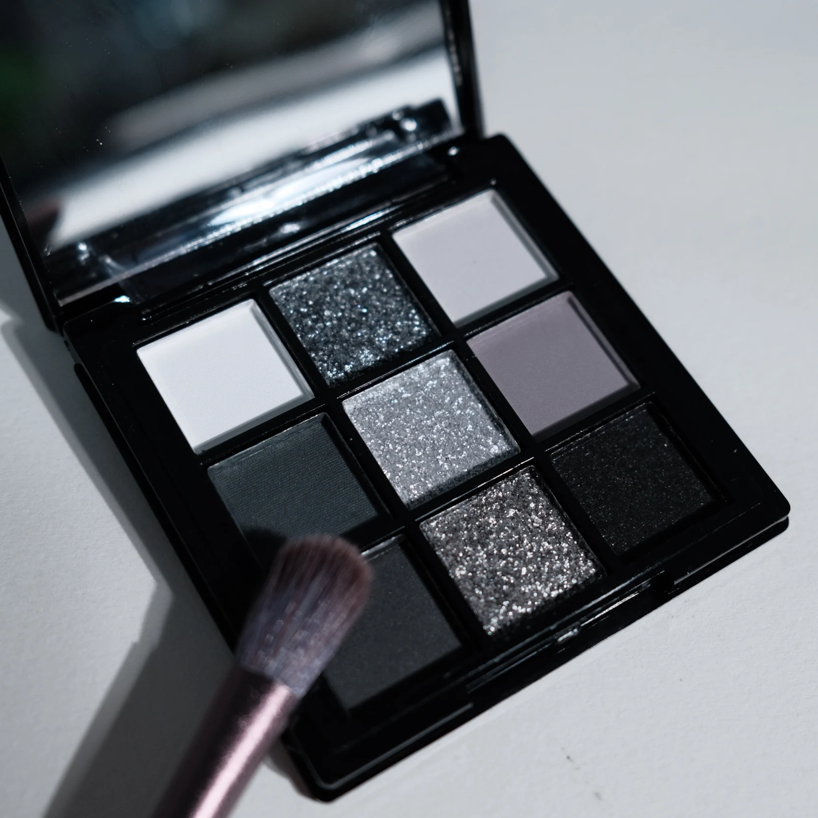 9-shade eyeshadow palette: Black Swan, Smoky, Dark Black, Grey Silver Glitter, M