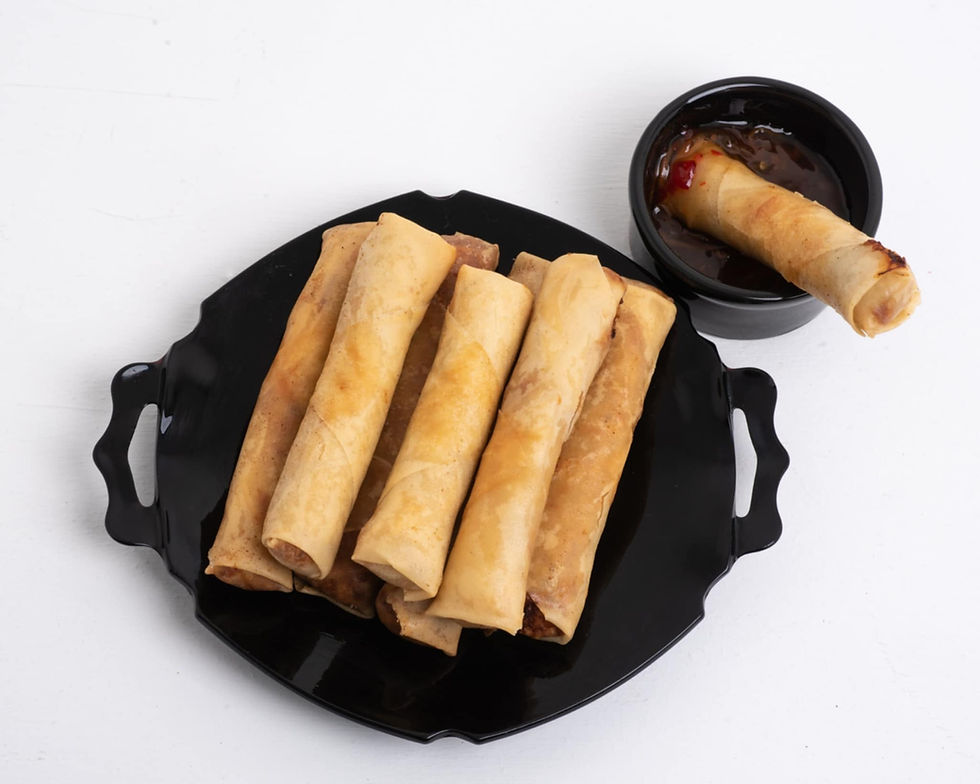 Close-up view of golden Cambodian egg rolls on a rustic plate