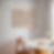 Horizontal Wooden frame mockup for poster 4x3 in a minimalistic dining room with a round table, flowers and natural light