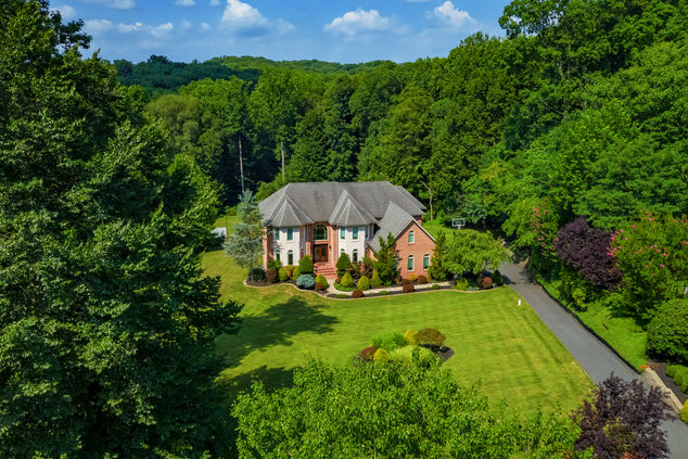 Aerial view of a residential property in Maryland captured by a drone, showcasing the layout, landscaping, and surrounding neighborhood, highlighting the use of advanced drone technology for real estate photography services in Maryland.