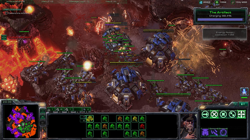 A sci-fi battle scene with blue armored units fighting aliens on a rocky, fiery terrain. "The Artifact" charge at 98.4%. Maps and stats visible.