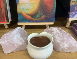 Rose quartz, a painting and a heart mug of cacao 