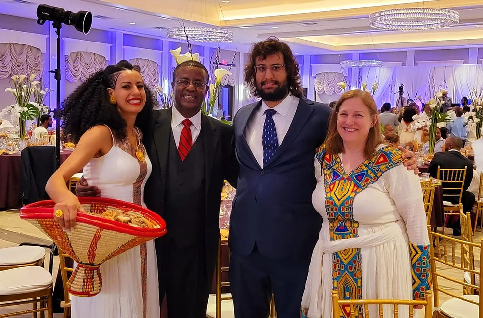 Betsy Woldeyohannes, father, mother, and brother at an Ethiopian wedding wearing traditional Ethiopian dress.