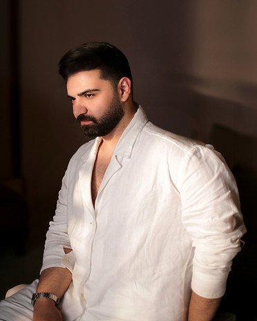 A man with a beard sitting on a bed_edit