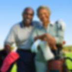 Smiling senior couple enjoying retirement on a golf course.