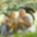Senior couple having a picnic with wine and bicycles.