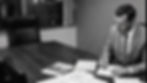 Black-and-white photo of Clinton Cagle focused on reviewing and signing case documents