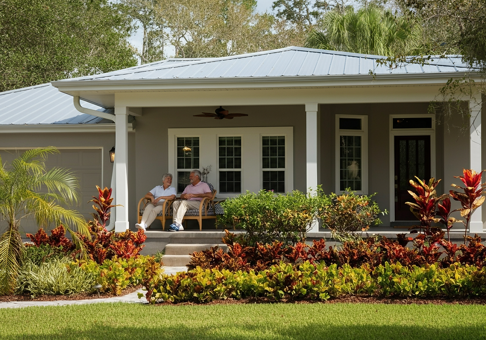 Elderly couple sitting in chairs on porch of house with green landscape