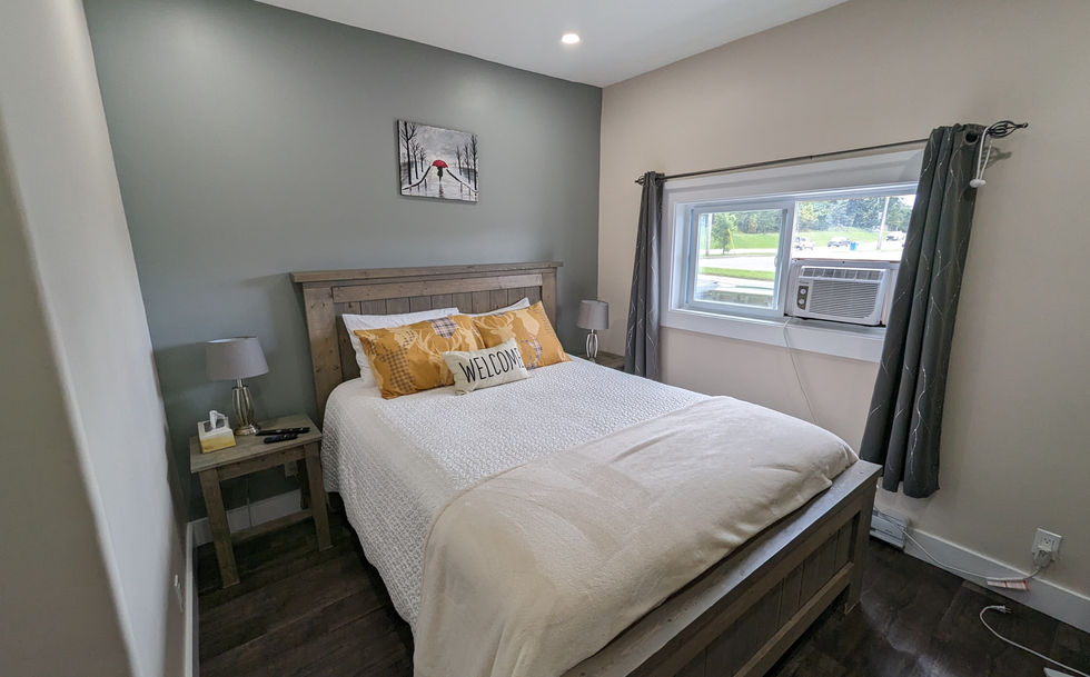 Queen size bed with Yellow Throw pillows and white bedspread