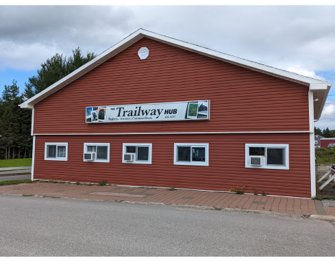 attractive deep red building with Trailway Hub sign
