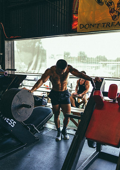 An elite athlete performs resistance training with science-based techniques under the supervision of a South and North Austin personal fitness coach.