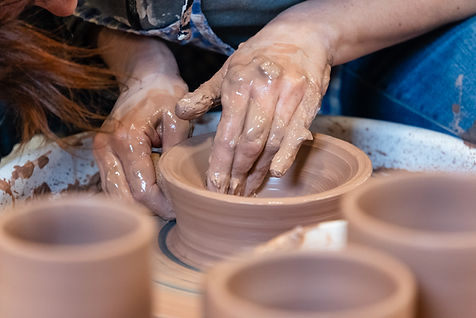 A person throwing a pot