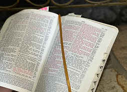 Open Bible with verses highlighted, showing text, and a ribbon marker. The Doyle Christian Church.