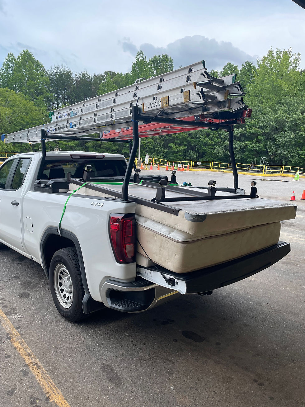 Junk Removal Pros NC removing an old mattress and bed frame from a home in Mooresville North Carolina near Lake Norman showing full service furniture disposal and hauling process