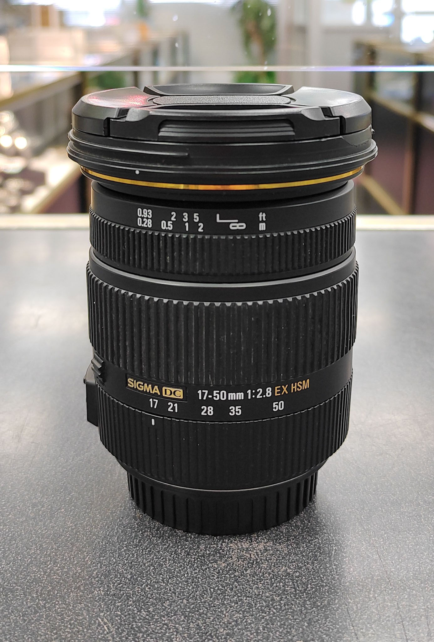 Sigma 17-50mm f/2.8 EX DC OS HSM Canon lens with front and rear caps