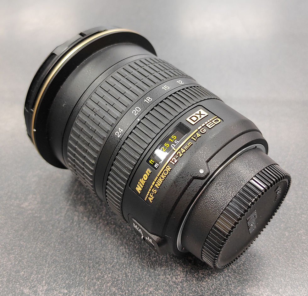 Nikon AF-S DX 12–24 mm f/4G ED IF Aspherical lens standing upright next to its soft pouch on a table