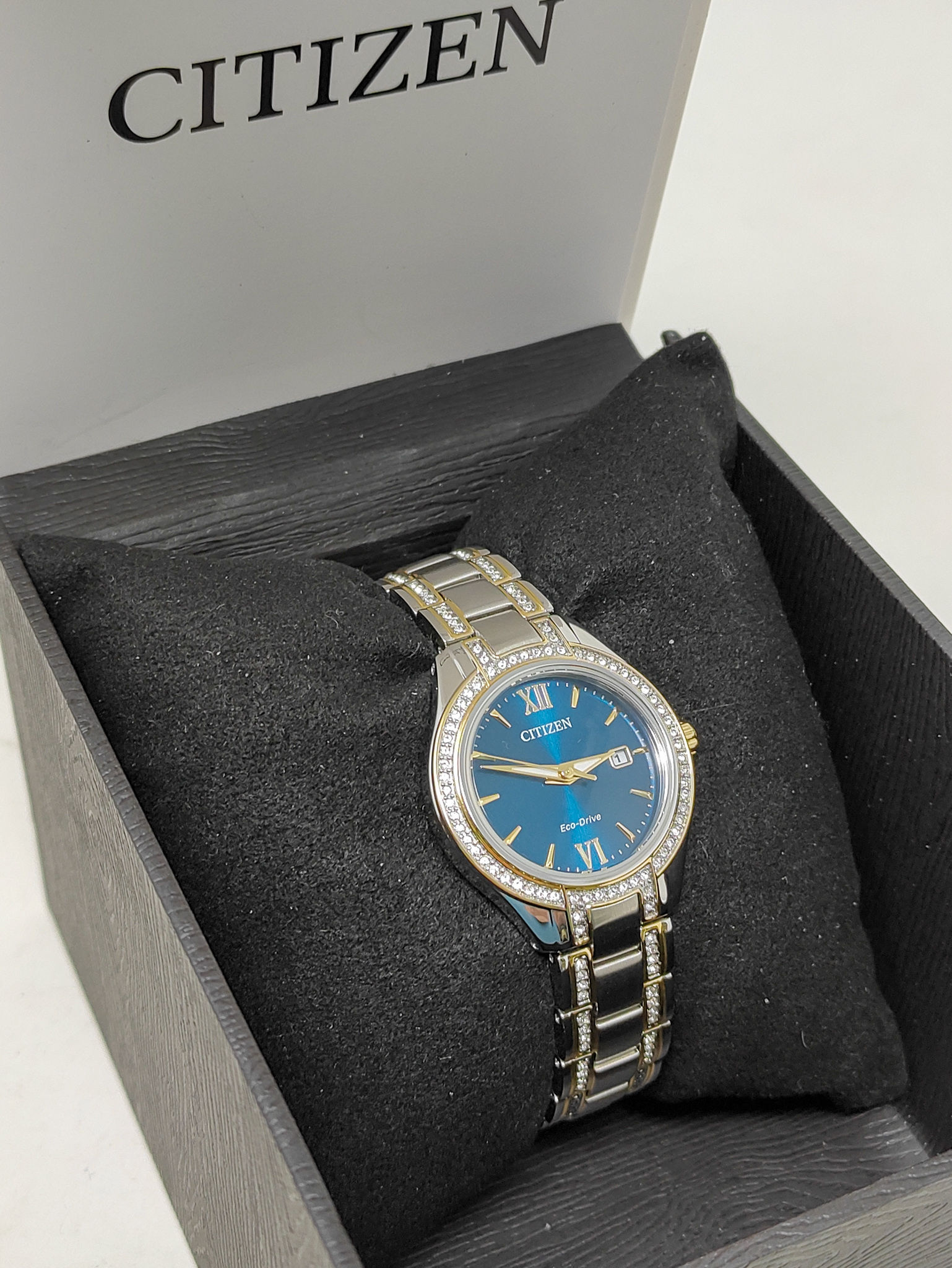 Citizen FE1234-50L Eco-Drive women’s two-tone watch with blue dial and crystal-accented bezel shown with original box