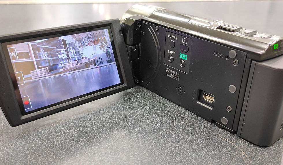 Thumbnail: Sony Handycam DCR-SX45 black camcorder shown from multiple angles with flip-out LCD, Carl Zeiss lens, battery compartment