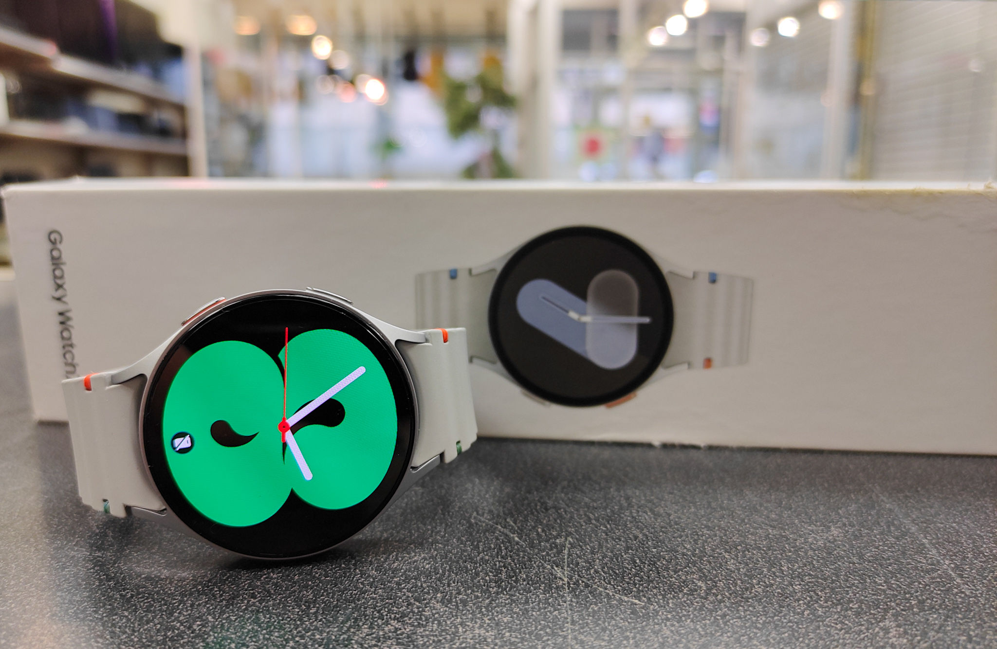 Silver Samsung Galaxy Watch7 LTE 44mm (SM-L315F) standing upright with watch face on, showing mint condition case and screen