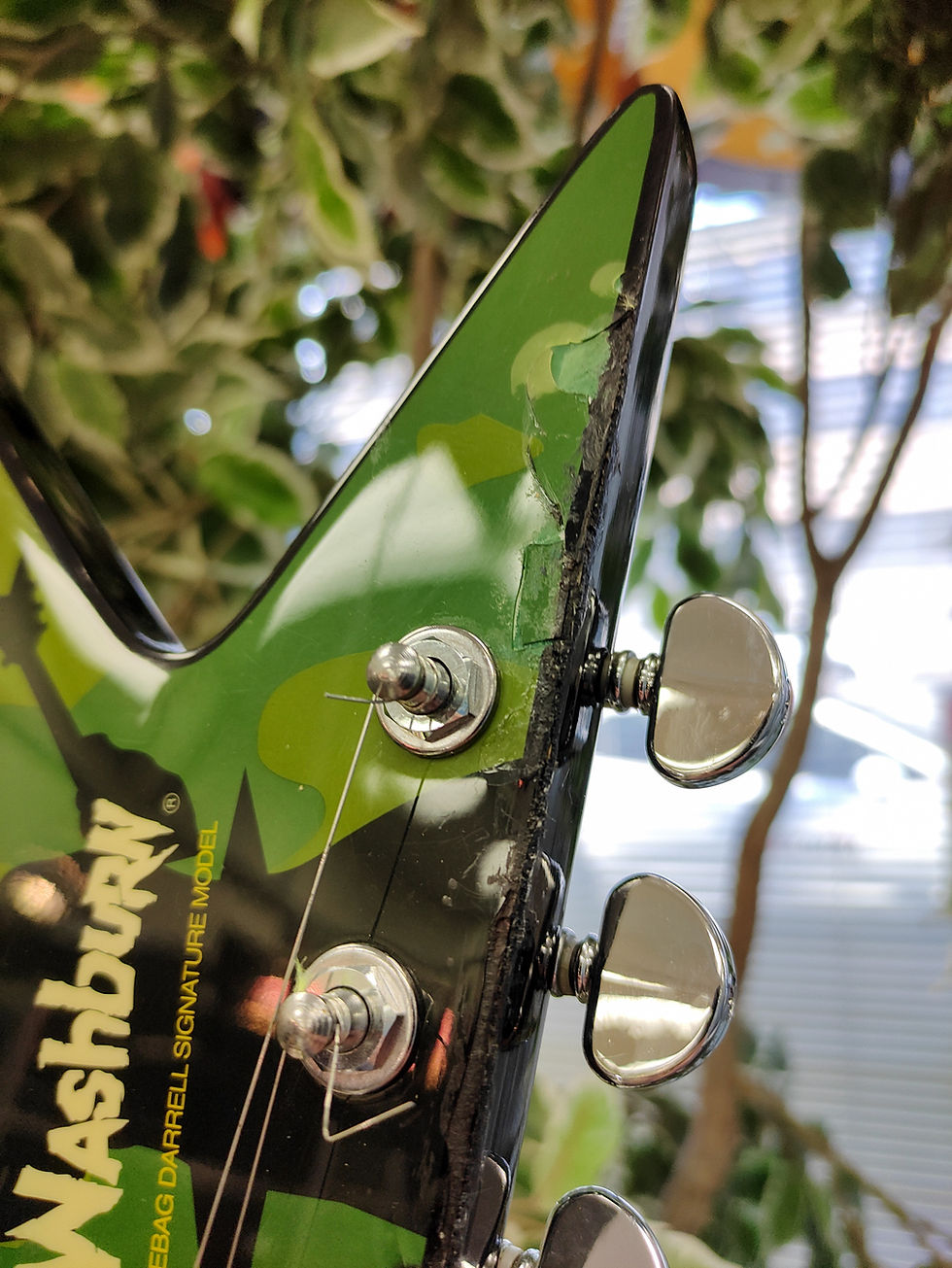 Thumbnail: Washburn Dimebag Darrell signature Dime V electric guitar in green camo finish with dual humbuckers and string-through V plat