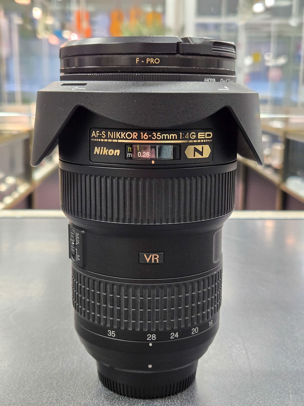 Nikon AF-S NIKKOR 16–35mm f/4G ED VR wide-angle zoom lens with hood attached, shown with 77mm Hoya and B+W filters