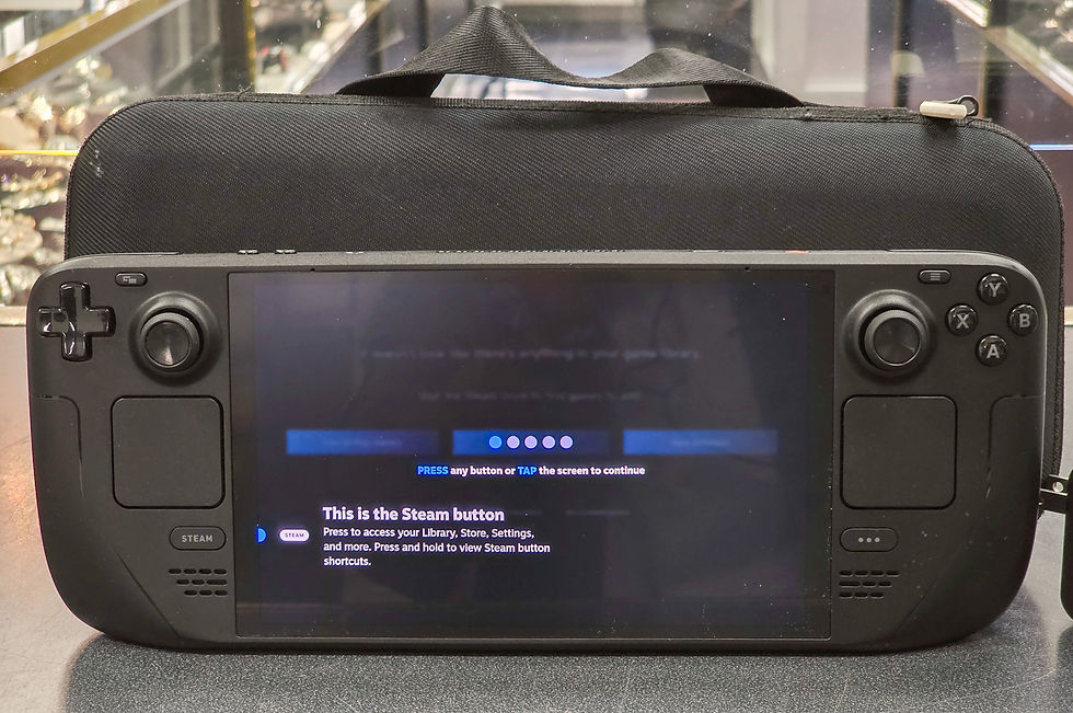 Steam Deck OLED 7.4-inch handheld gaming console with 1TB storage shown powered on with original carrying case and charger.