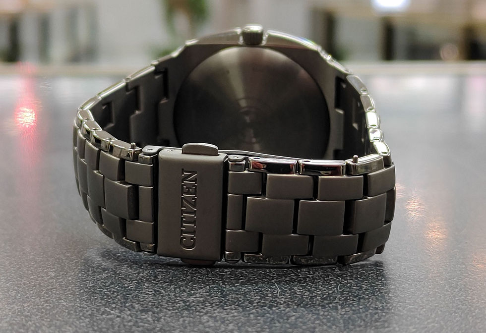 Thumbnail: Citizen Eco-Drive Titanium E111-R009532 watch with titanium case, bracelet, and titanium-tone dial shown from front, side.