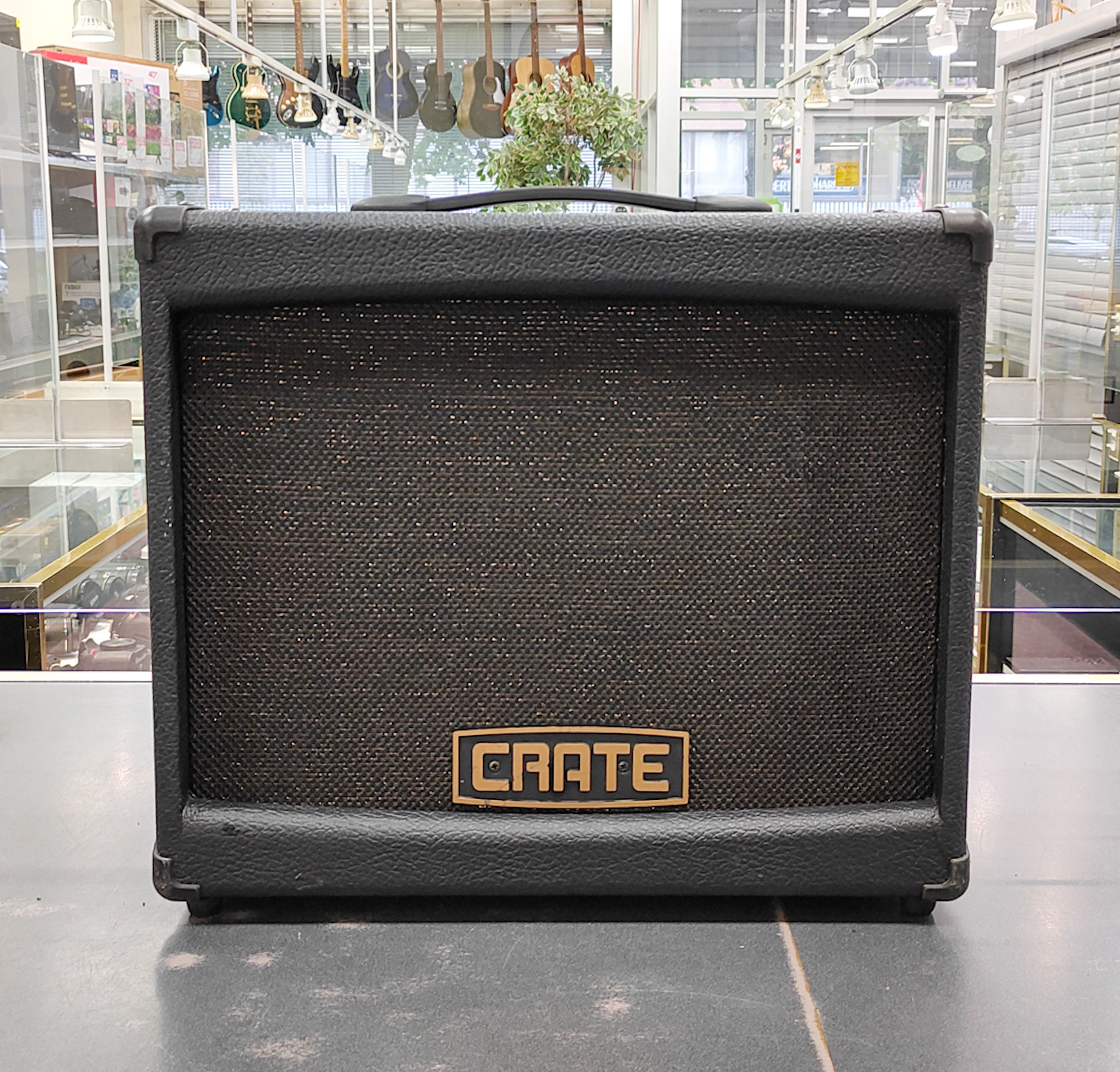Crate DXB112 digital guitar amplifier in very good condition, showing front grille with logo, back panel inputs, top controls