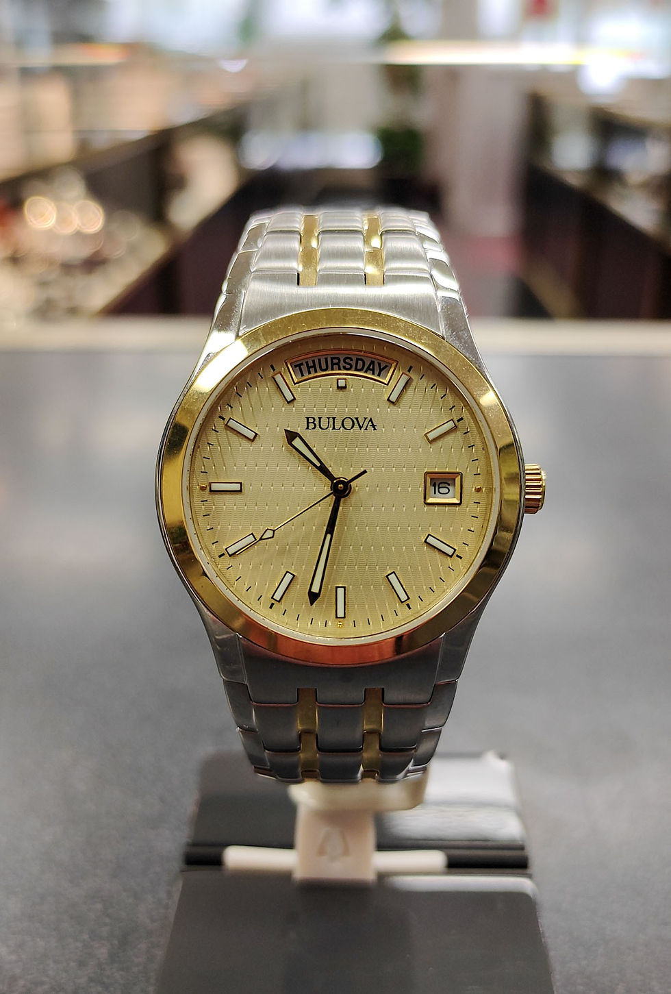 Thumbnail: Bulova 98C60 two-tone stainless steel watch with champagne dial and date shown from front, side, and caseback