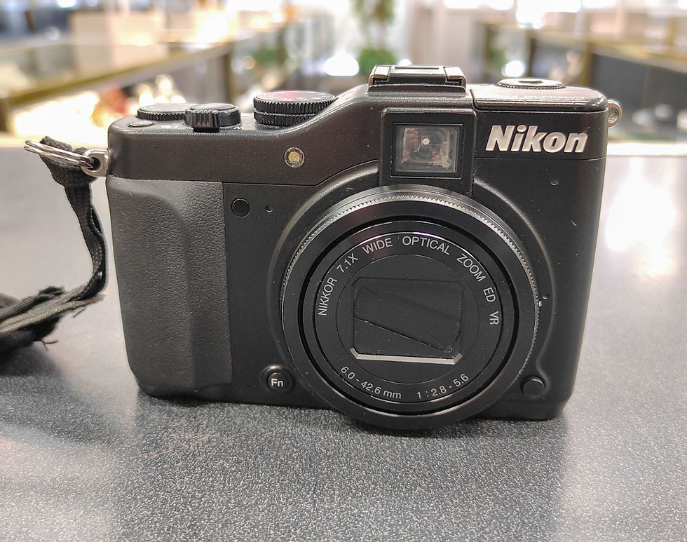 Nikon COOLPIX P7000 black compact digital camera in excellent condition shown with two original Nikon batteries, MH24 charger