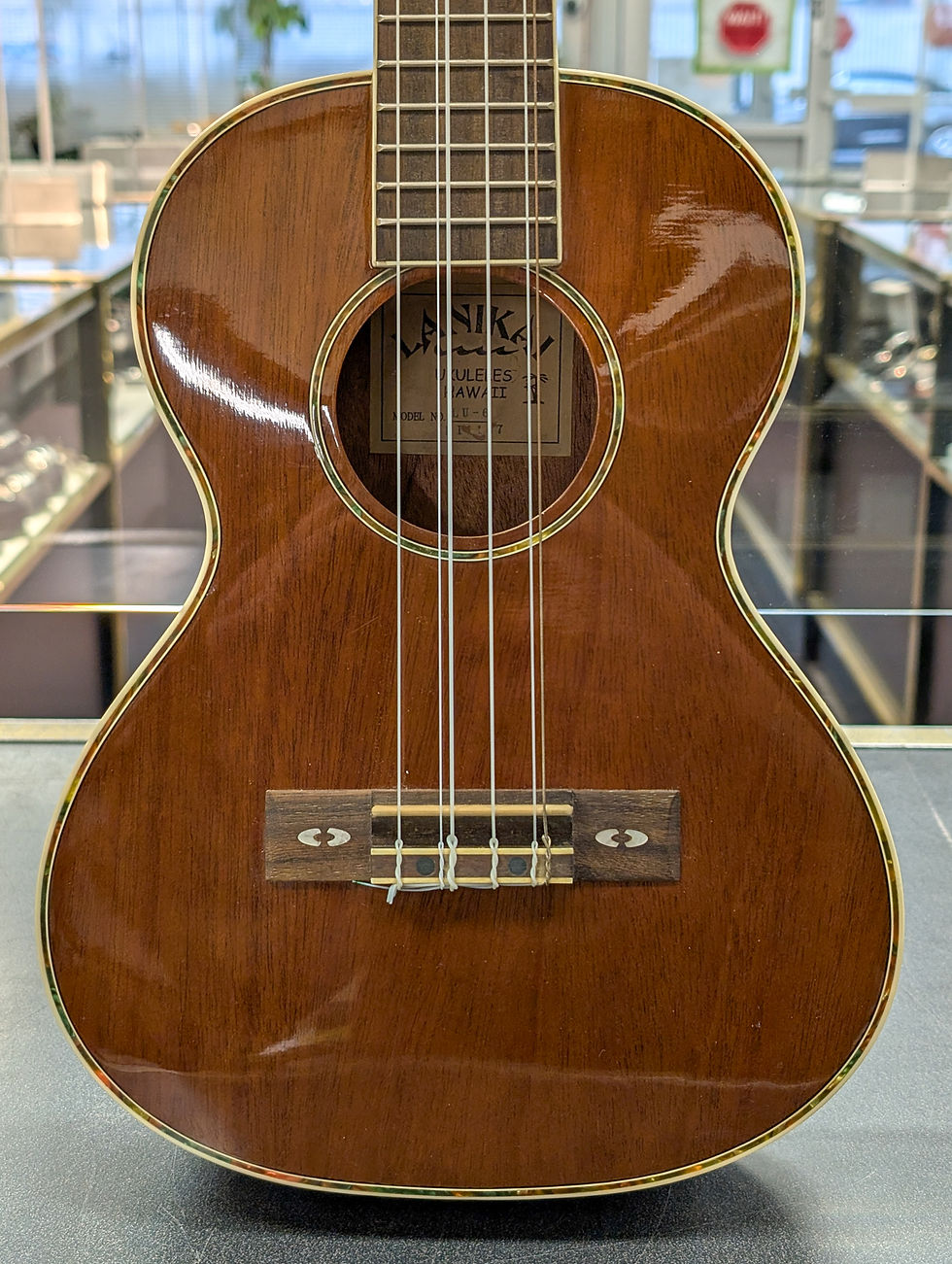 Lanikai LU6/LULU6S 6-string tenor ukulele shown from front, back, headstock, and bridge angles with included gig bag.
