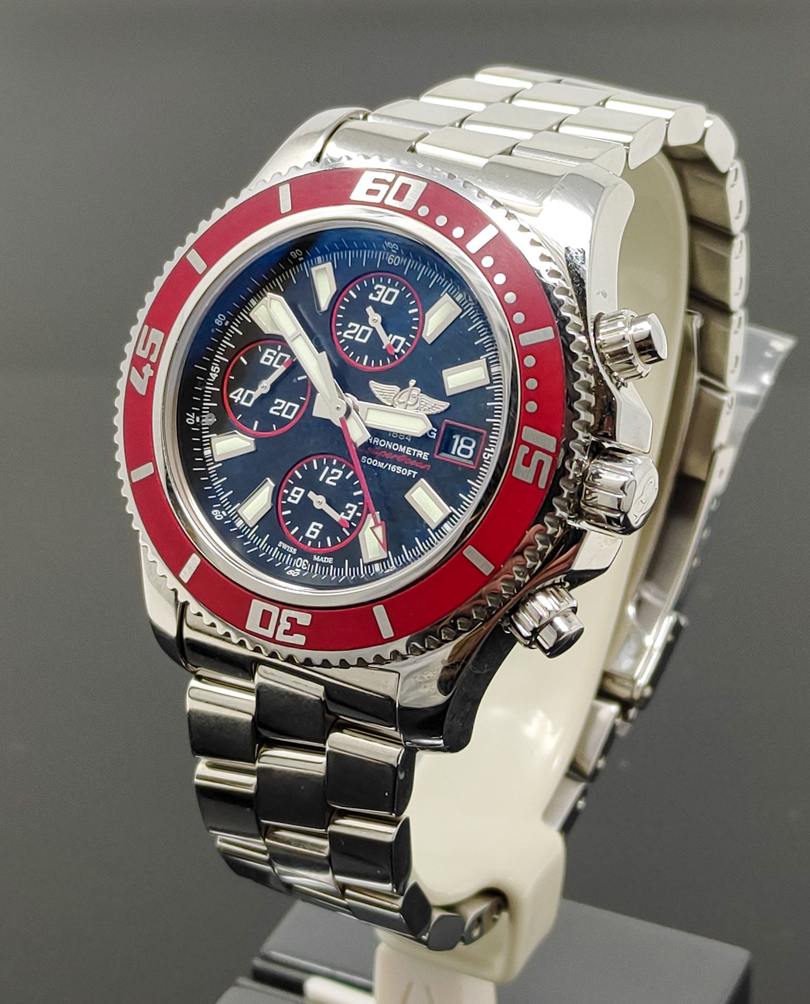 Brand new Breitling Superocean Chronograph II with red bezel, black Abyss dial, and stainless steel bracelet, limited edition