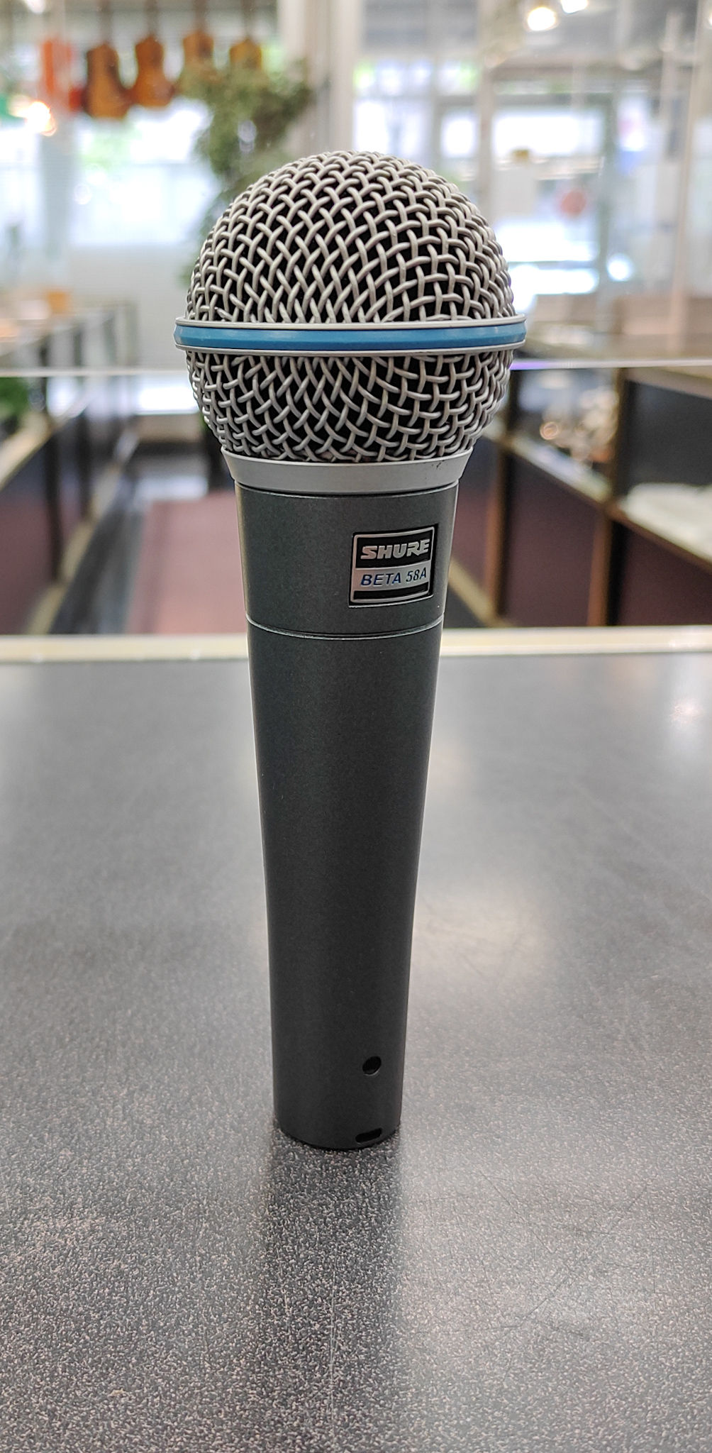 Shure Beta 58A supercardioid dynamic vocal microphone shown from multiple angles, including close-ups of the grille, body, XL