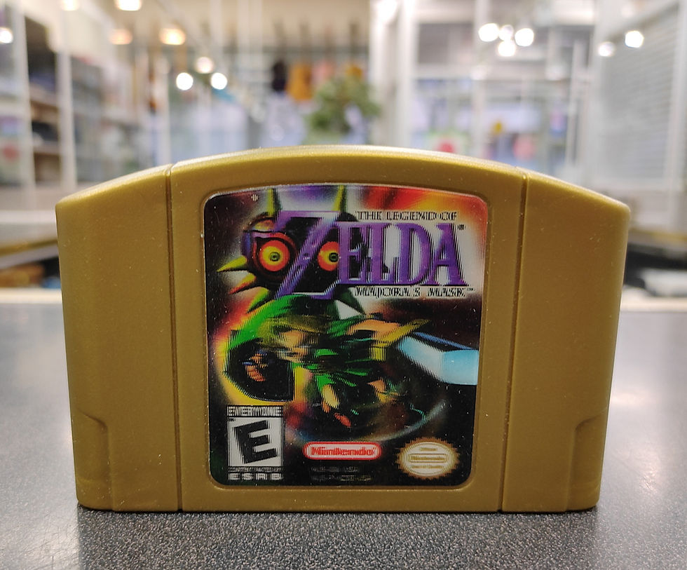Gold N64 cartridge of The Legend of Zelda: Majora’s Mask, front label visible, loose cart on counter