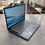 Thumbnail: Lenovo IdeaPad 1i 14-inch laptop in Abyss Blue powered on with original Lenovo charger shown