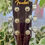 Thumbnail: Fender FA-100 acoustic guitar in natural finish showing the Fender FA-100 label, pickguard, body wear on the side