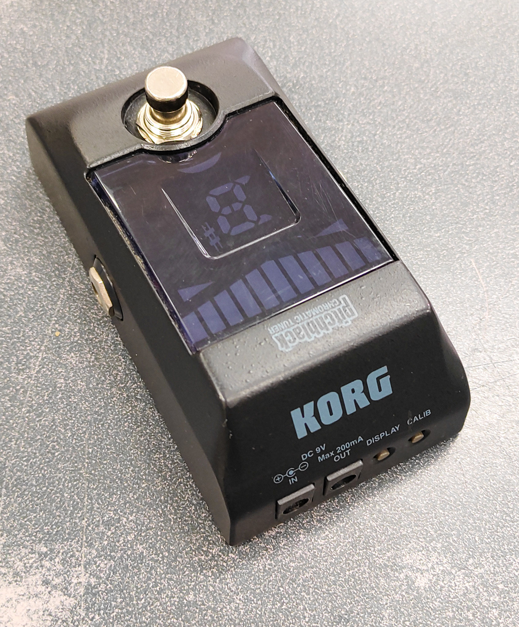 Korg Pitchblack PB-01 chromatic tuner pedal with visible used wear and scratched display lens