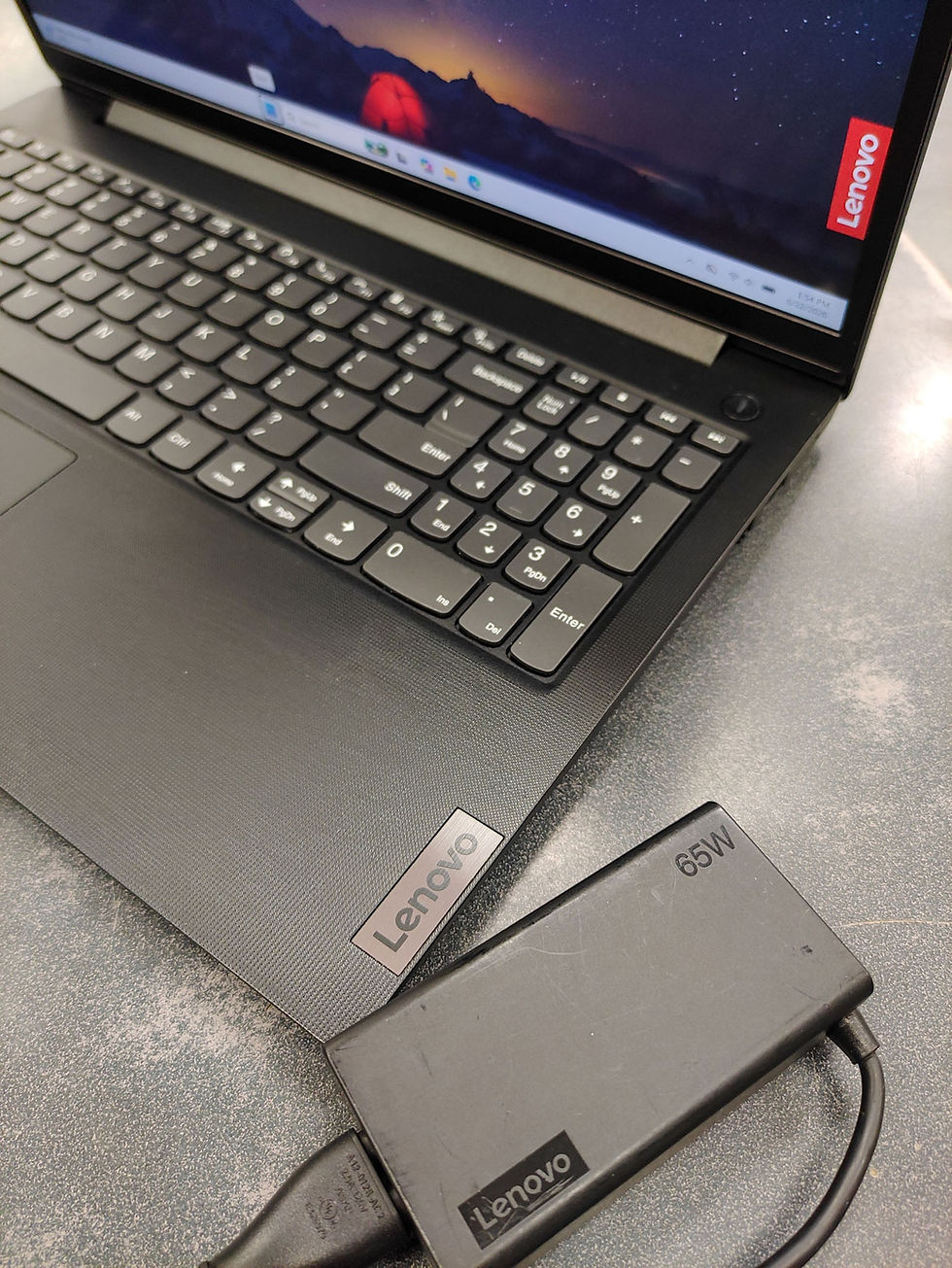 Thumbnail: Lenovo V15 G4 ABP 15.6-inch black laptop with original Lenovo 65W charger, shown powered on with Windows 11 Pro