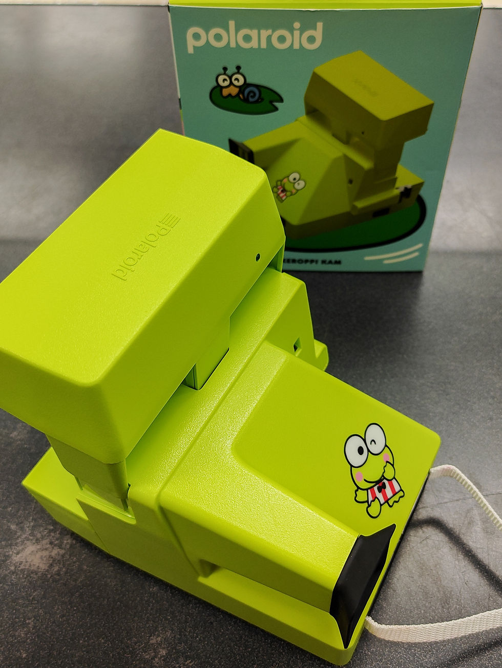 Thumbnail: Bright lime-green Polaroid 600 Keroppi Kam instant film camera with original box, shown from multiple angles with open film