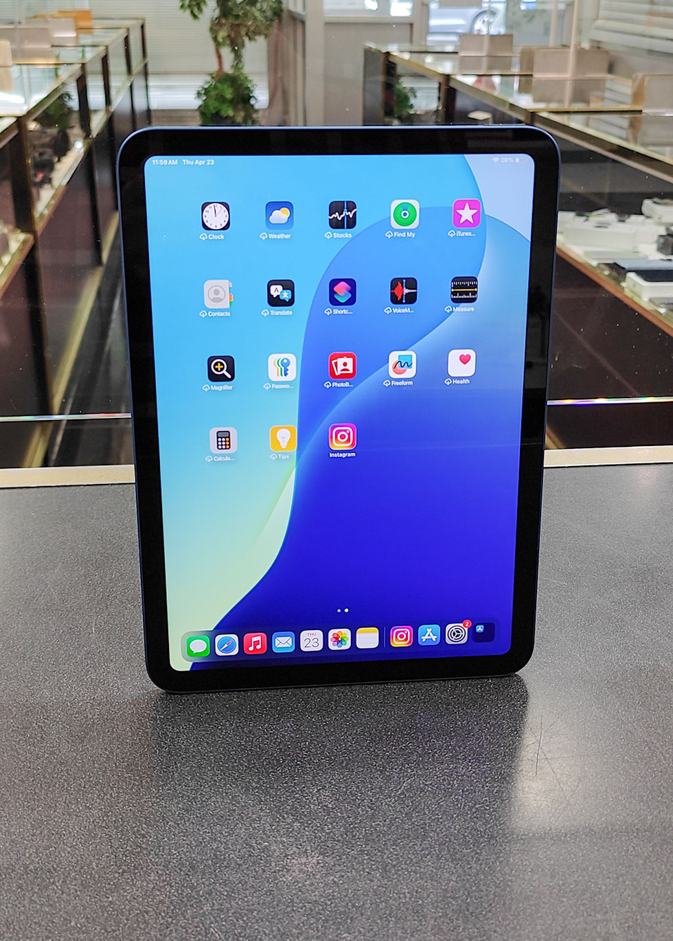 Blue Apple iPad A16 11-inch 128GB Wi-Fi tablet in mint condition, shown powered on from front and back, with clean screen