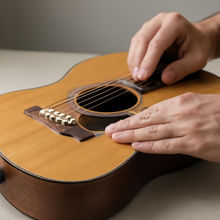 What to check for bridge lift or top bellying on an acoustic guitar