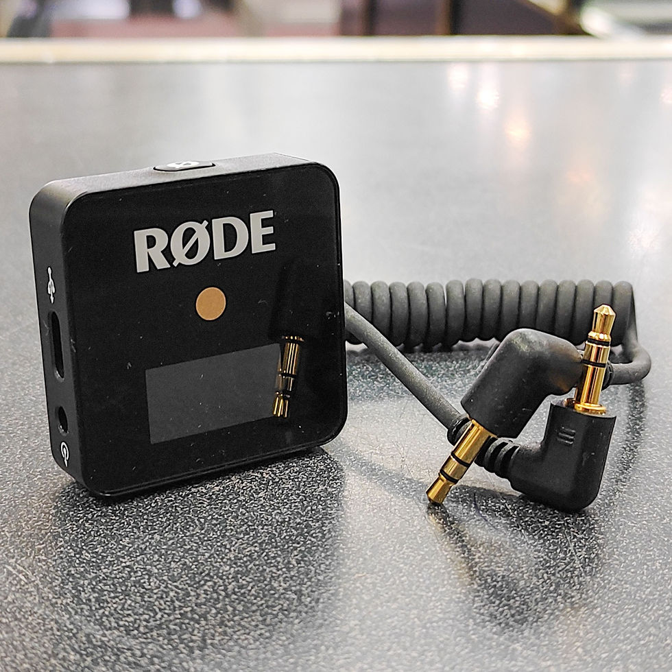 Thumbnail: Black RØDE Wireless GO first-generation receiver with built-in clip, display, USB-C charging port, and coiled 3.5mm TRS cable