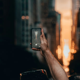 A person looking at a smartphone in the dark at night.
